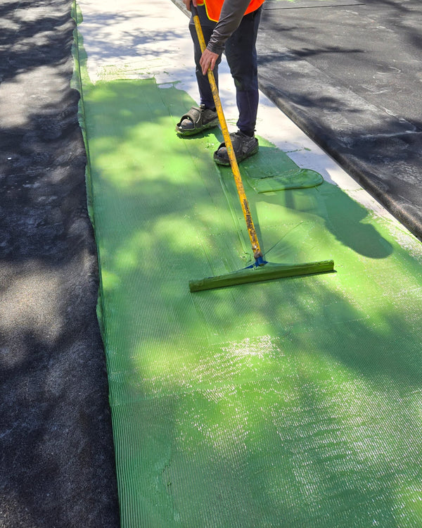 Applying the CLOUDFUSE adhesive for the CLOUD Cushion force reduction mat system.