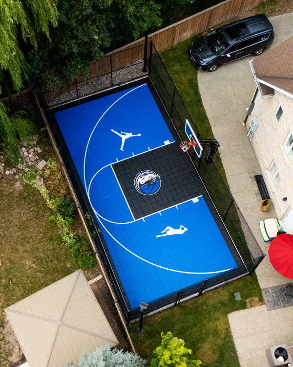 Custom size HEXPRO Sport Tile Basketball Court in a Legacy Blue & Phantom Black colorway with 3 custom logos of their favorite players & team.