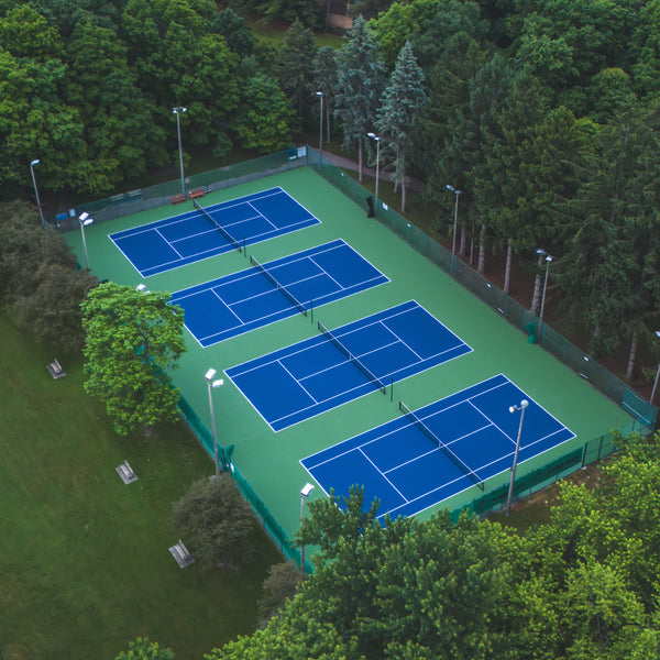 Private tennis club facility featuring four courts with EIGHTYNINE Sports tennis posts and nets.
