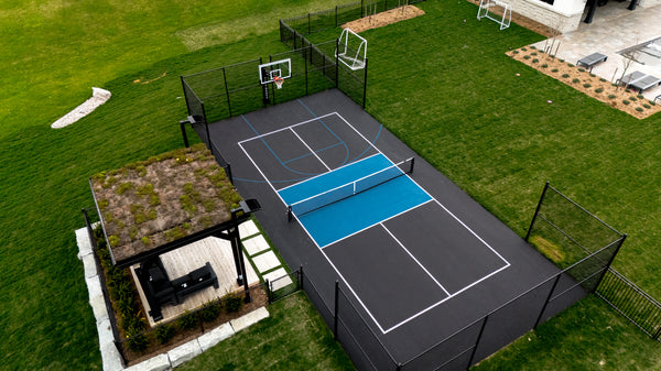 EIGHTYNINE Sports in-ground pickleball posts and net installed on a residential pickleball court.