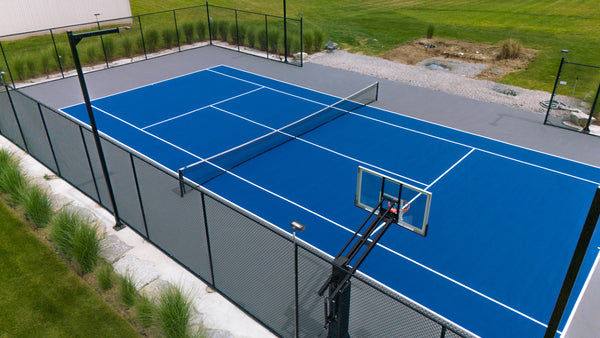 Residential tennis court featuring EIGHTYNINE Sports in-ground posts and net on a CLOUD Cushion surface.