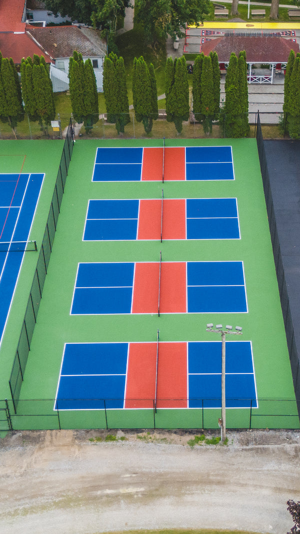 Four pickleball courts installed at a summer resort facility.