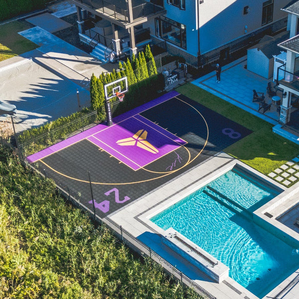 HEXPRO Sport Tile Basketball Court in Royal Purple and Phantom Black colorway with 4 custom tribute logos of the customers favorite player.