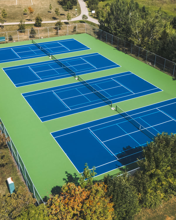 Four tennis & shared pickleball courts at a public community facility equipped with EIGHTYNINE Sports posts and nets.