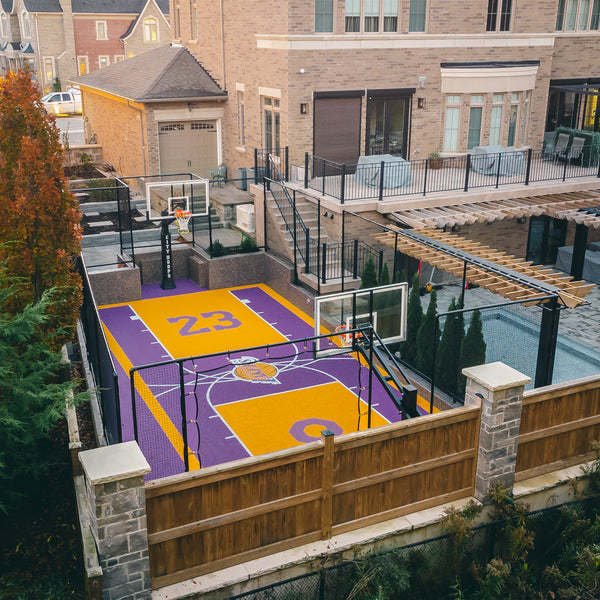 Custom Size HEXPORT Sport Tile Basketball Court in Solar Yellow & Royal Purple colorway with 3 custom logos of their favorite team and players.