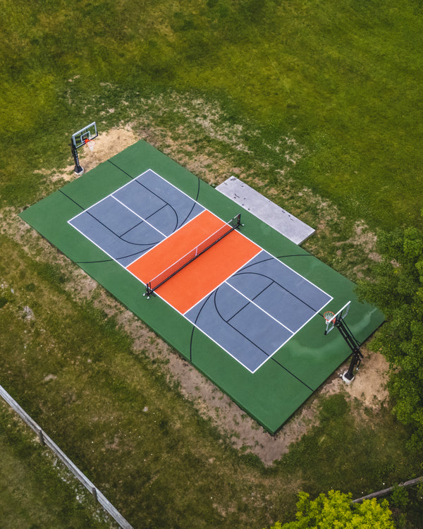 Portable Professional Pickleball Net System set up on a residential multi-use court.