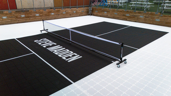 Custom brand activation court for Steve Madden with HEXPRO Sport Tiles in Phantom Black & Standard White with custom logo & PX Portable Pickleball Net by EIGHTYNINE Sports.