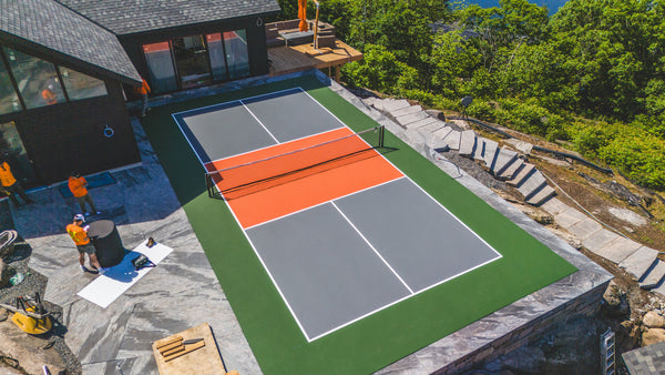 Cottage pickleball court featuring EIGHTYNINE Sports in-ground pickleball posts and net.