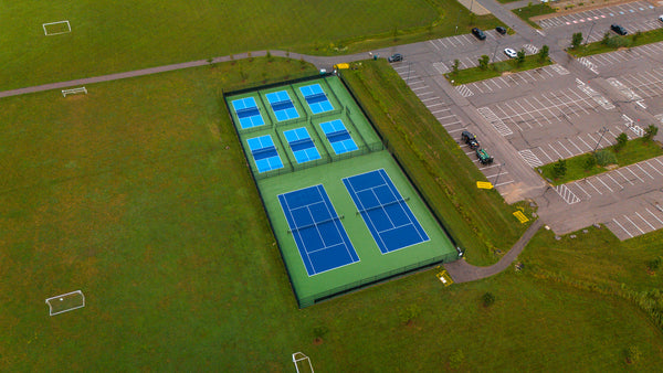 Public outdoor tennis and pickleball facility featuring EIGHTYNINE Sports posts and nets.