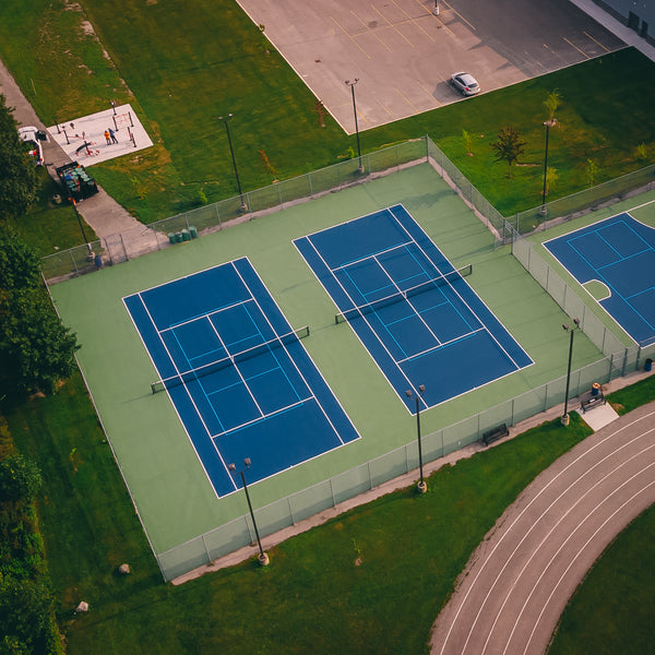 EIGHTYNINE Sports tennis posts and nets installed at a public tennis facility.